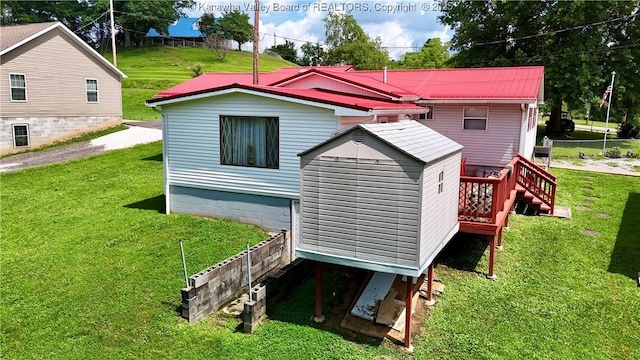 169 Myrtle Tree Rd, South Charleston, WV 25309 - rear view of house with a storage shed, a yard, and a metal roof
