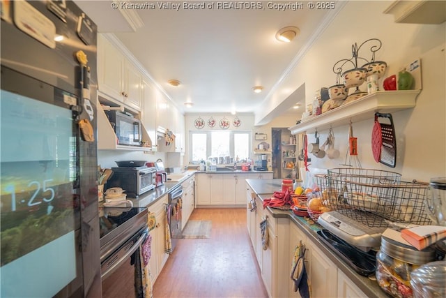 1324 Kanawha Ave, Dunbar, WV 25064 - kitchen featuring stainless steel appliances, ornamental molding, light wood-style flooring, white cabinetry, and dark countertops