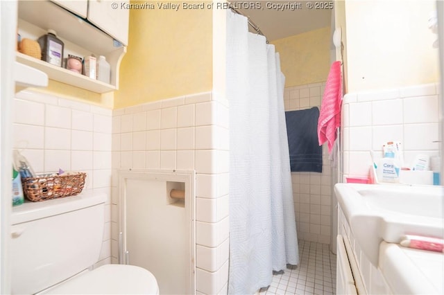1324 Kanawha Ave, Dunbar, WV 25064 - bathroom featuring tile walls, vanity, a shower with shower curtain, a wainscoted wall, and tile patterned floors