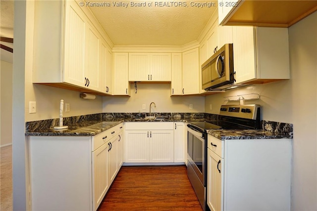 55 Corky Dr, Poca, WV 25159 - kitchen featuring stainless steel appliances, dark stone countertops, white cabinetry, and a textured ceiling