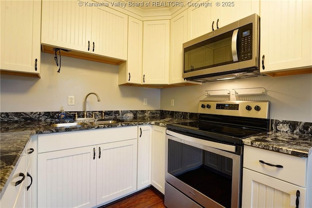 55 Corky Dr, Poca, WV 25159 - kitchen featuring stainless steel appliances, dark stone counters, and white cabinetry