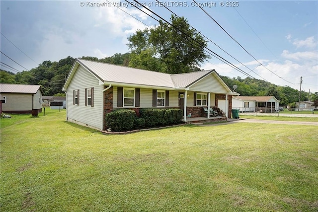 55 Corky Dr, Poca, WV 25159 - single story home featuring covered porch, a front yard, driveway, and a metal roof