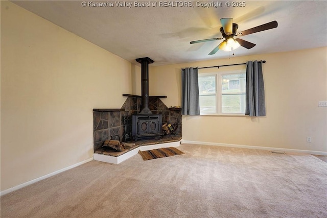 55 Corky Dr, Poca, WV 25159 - unfurnished living room with a wood stove, carpet, and ceiling fan