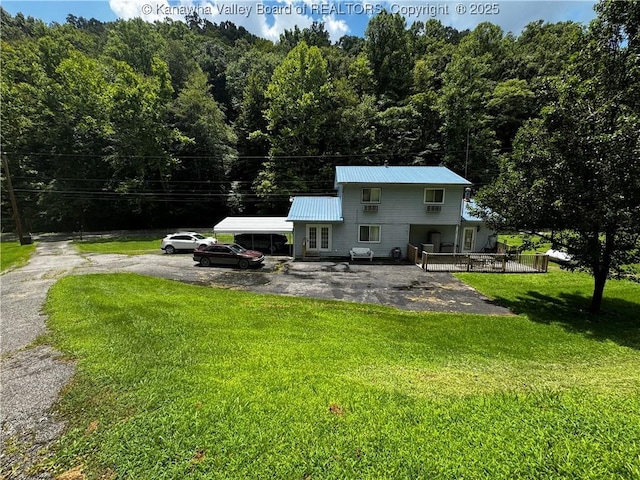 1198 Caney Branch Rd, Chapmanville, WV 25508 - rear view of property featuring a lawn, a metal roof, and a view of trees