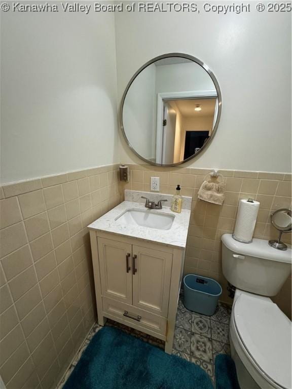 1198 Caney Branch Rd, Chapmanville, WV 25508 - half bathroom with tile walls, vanity, wainscoting, and tile patterned floors
