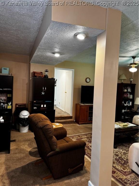 1198 Caney Branch Rd, Chapmanville, WV 25508 - carpeted living area with a textured ceiling and ceiling fan