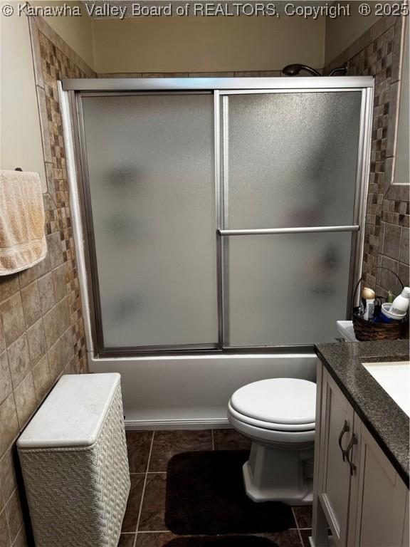 1198 Caney Branch Rd, Chapmanville, WV 25508 - bathroom with tile walls, vanity, tile patterned floors, and enclosed tub / shower combo