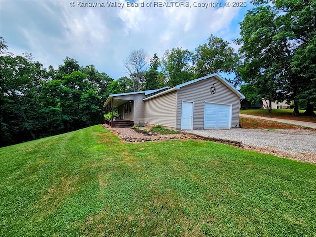 438 Tanglewood Dr, Point Pleasant, WV 25550 - view of front of house with a front lawn, gravel driveway, and a garage
