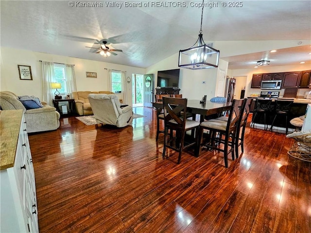438 Tanglewood Dr, Point Pleasant, WV 25550 - dining room featuring dark wood finished floors, lofted ceiling, ceiling fan, and a chandelier
