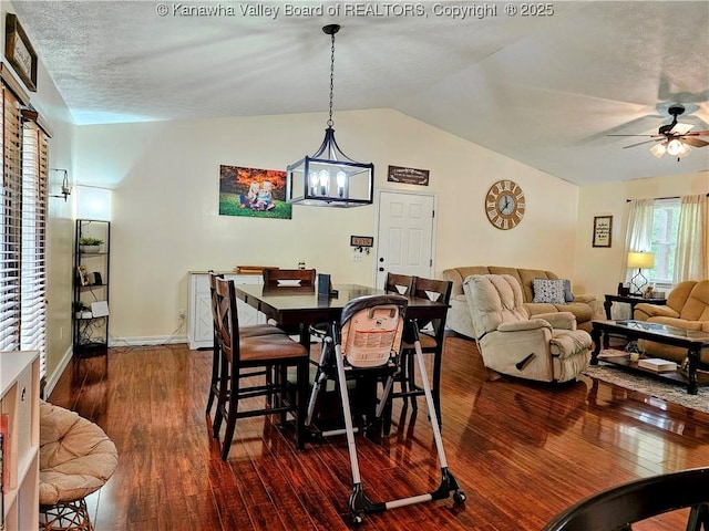 438 Tanglewood Dr, Point Pleasant, WV 25550 - dining room with ceiling fan, a chandelier, dark wood-style floors, and vaulted ceiling