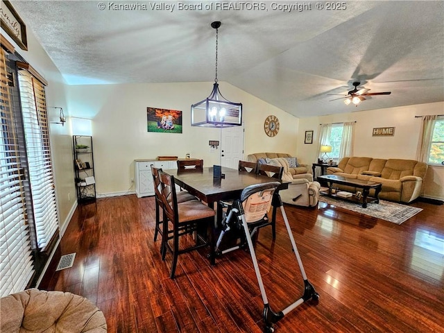 438 Tanglewood Dr, Point Pleasant, WV 25550 - dining area featuring dark wood-style floors, vaulted ceiling, ceiling fan, and a chandelier