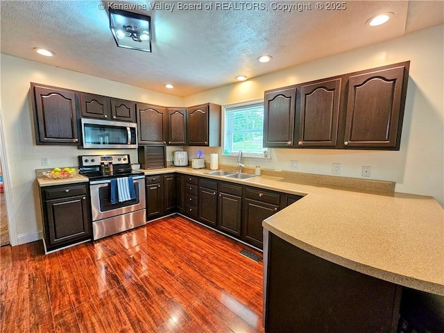 438 Tanglewood Dr, Point Pleasant, WV 25550 - kitchen featuring appliances with stainless steel finishes, dark wood finished floors, dark brown cabinetry, light countertops, and recessed lighting