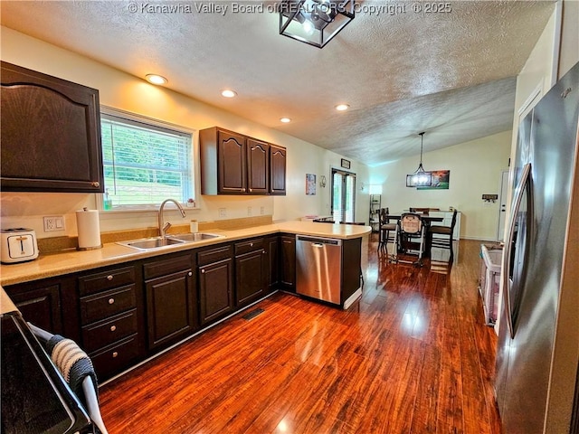 438 Tanglewood Dr, Point Pleasant, WV 25550 - kitchen featuring appliances with stainless steel finishes, a textured ceiling, a peninsula, dark brown cabinetry, and dark wood-style floors