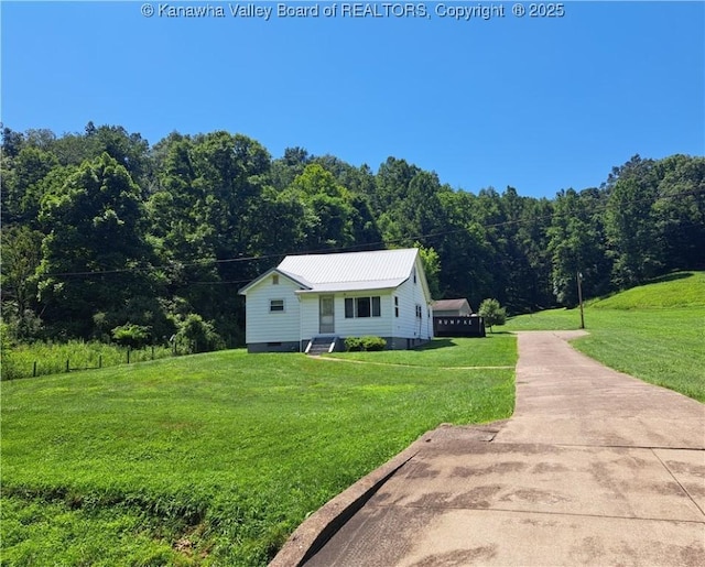 588 Saunders Creek Rd, Milton, WV 25541 - bungalow featuring a forest view, a front yard, crawl space, and a metal roof