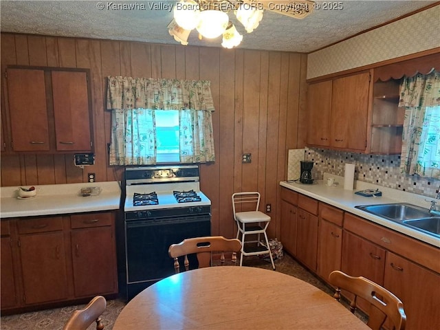 588 Saunders Creek Rd, Milton, WV 25541 - kitchen featuring gas stove, light countertops, a textured ceiling, brown cabinetry, and open shelves