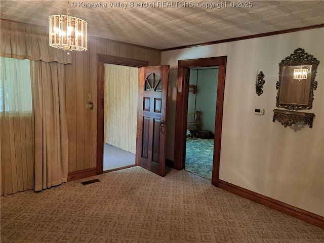 588 Saunders Creek Rd, Milton, WV 25541 - unfurnished room featuring a chandelier, carpet flooring, ornamental molding, an ornate ceiling, and wood walls