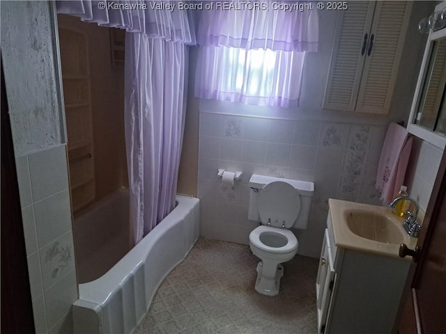 588 Saunders Creek Rd, Milton, WV 25541 - full bathroom with vanity, shower / bath combo with shower curtain, tile walls, and tile patterned flooring