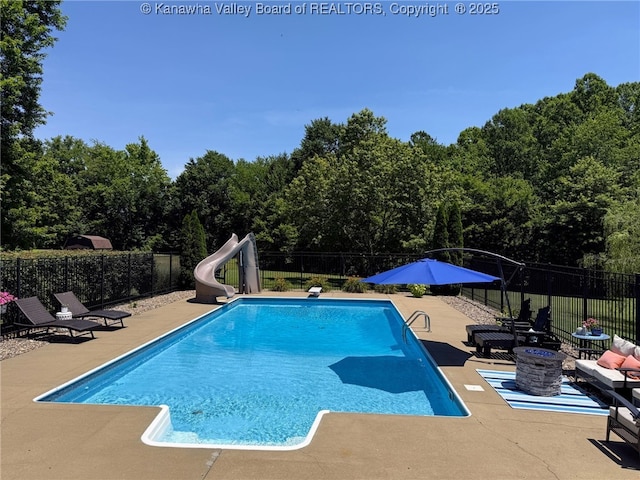 255 Stoney Brook Dr, Point Pleasant, WV 25550 - view of swimming pool featuring a water slide, a patio, a forest view, and a diving board