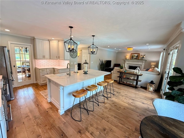 255 Stoney Brook Dr, Point Pleasant, WV 25550 - kitchen with open floor plan, freestanding refrigerator, healthy amount of natural light, a kitchen bar, and crown molding