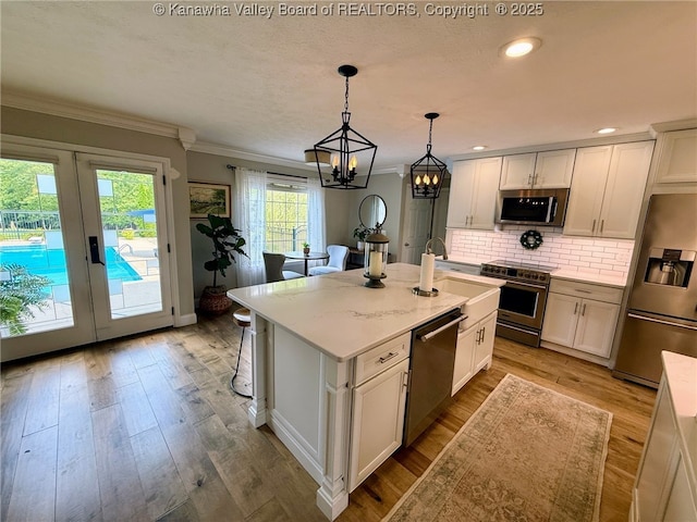 255 Stoney Brook Dr, Point Pleasant, WV 25550 - kitchen with appliances with stainless steel finishes, crown molding, backsplash, a chandelier, and white cabinets