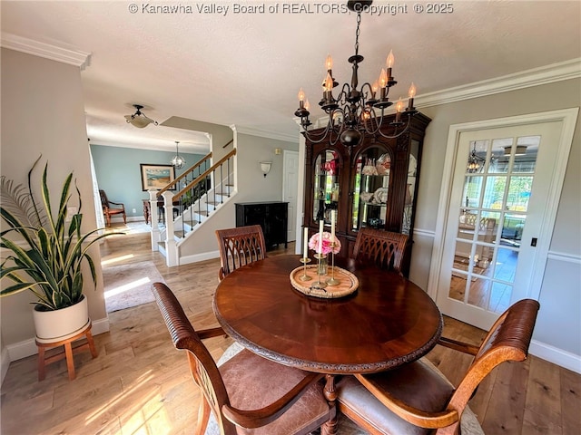 255 Stoney Brook Dr, Point Pleasant, WV 25550 - dining space with a chandelier, stairs, light wood finished floors, crown molding, and a textured ceiling