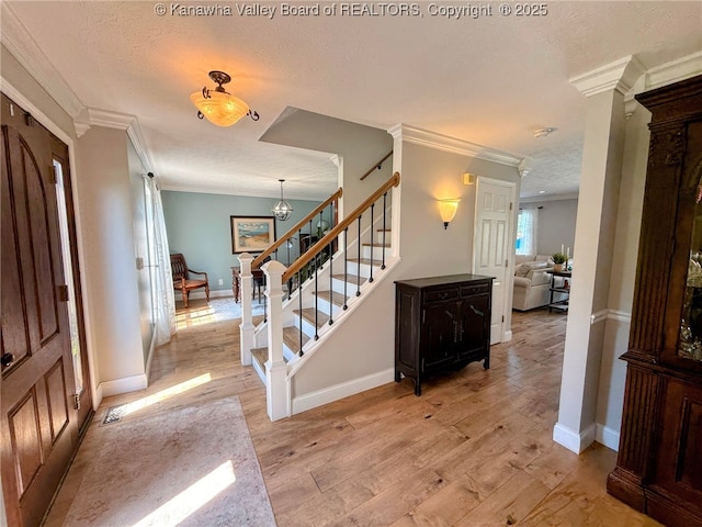 255 Stoney Brook Dr, Point Pleasant, WV 25550 - entryway featuring crown molding, light wood-type flooring, stairs, and a textured ceiling