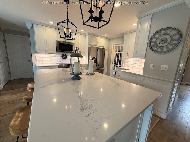 255 Stoney Brook Dr, Point Pleasant, WV 25550 - kitchen with appliances with stainless steel finishes, a chandelier, ornamental molding, tasteful backsplash, and dark wood-type flooring