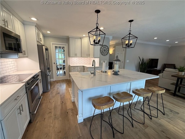255 Stoney Brook Dr, Point Pleasant, WV 25550 - kitchen featuring appliances with stainless steel finishes, crown molding, backsplash, a kitchen bar, and a spacious island