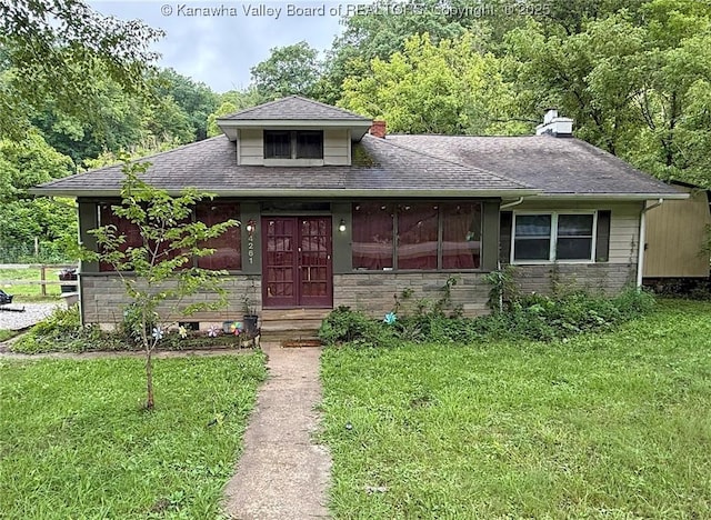 4261 Washington St W, Dunbar, WV 25313 - bungalow-style home with a front yard, stone siding, a chimney, and roof with shingles