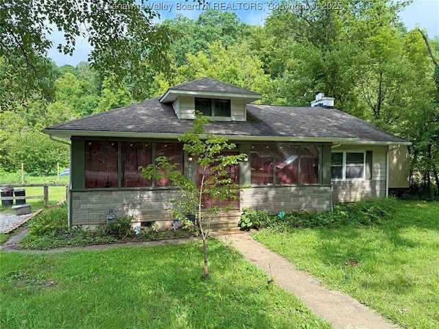 4261 Washington St W, Dunbar, WV 25313 - bungalow-style house featuring a wooded view, a chimney, roof with shingles, and a sunroom