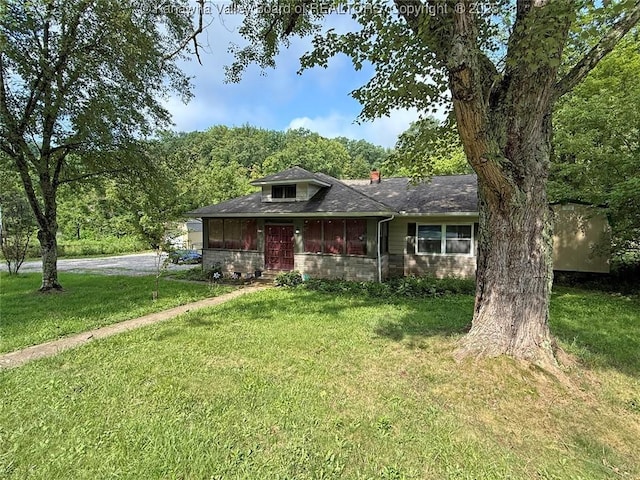4261 Washington St W, Dunbar, WV 25313 - view of front facade featuring a front lawn, roof with shingles, a view of trees, a chimney, and driveway