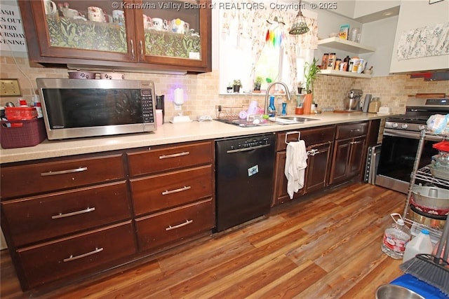 4261 Washington St W, Dunbar, WV 25313 - kitchen featuring stainless steel appliances, custom exhaust hood, tasteful backsplash, light wood-type flooring, and light countertops