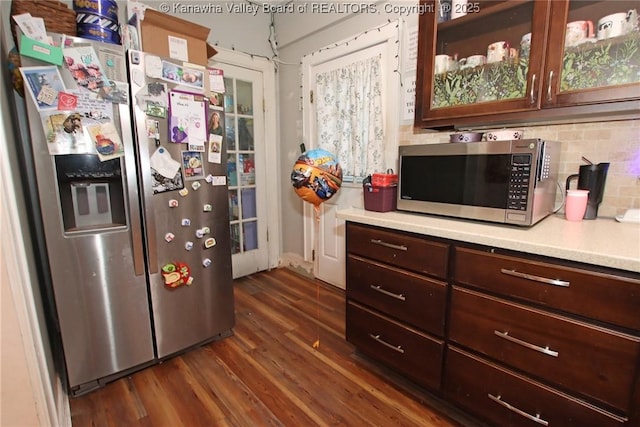 4261 Washington St W, Dunbar, WV 25313 - kitchen with appliances with stainless steel finishes, light countertops, dark wood-type flooring, backsplash, and glass insert cabinets