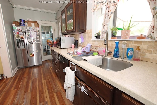4261 Washington St W, Dunbar, WV 25313 - kitchen featuring appliances with stainless steel finishes, light countertops, dark wood-style floors, decorative backsplash, and glass insert cabinets