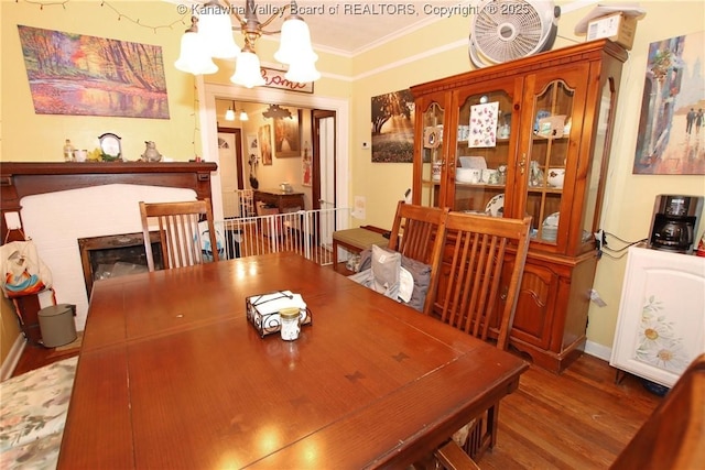 4261 Washington St W, Dunbar, WV 25313 - dining space featuring a chandelier, crown molding, wood finished floors, and a fireplace