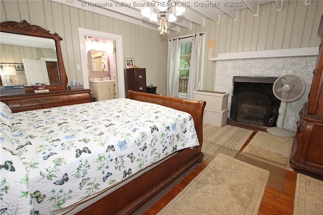 4261 Washington St W, Dunbar, WV 25313 - bedroom with wood finished floors, a fireplace, beam ceiling, ensuite bathroom, and wood walls