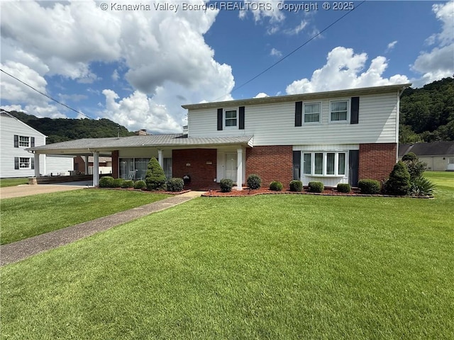 105 Sayer Cir, Logan, WV 25601 - traditional-style home featuring brick siding and a front yard