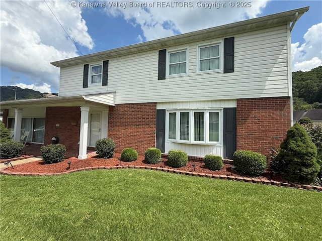 105 Sayer Cir, Logan, WV 25601 - view of front of house featuring brick siding and a front yard