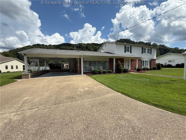 105 Sayer Cir, Logan, WV 25601 - view of front of property featuring concrete driveway, a front lawn, brick siding, and an attached carport