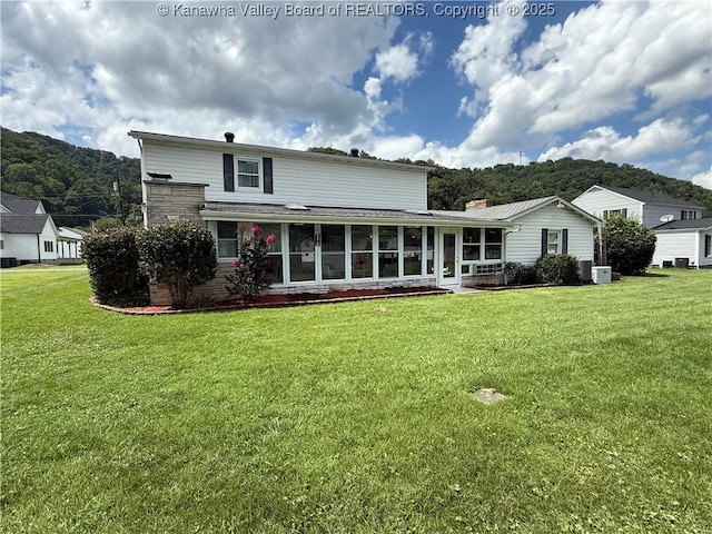 105 Sayer Cir, Logan, WV 25601 - back of house with a sunroom, a yard, and a chimney