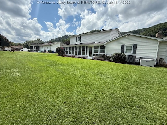 105 Sayer Cir, Logan, WV 25601 - back of property featuring a sunroom and a lawn
