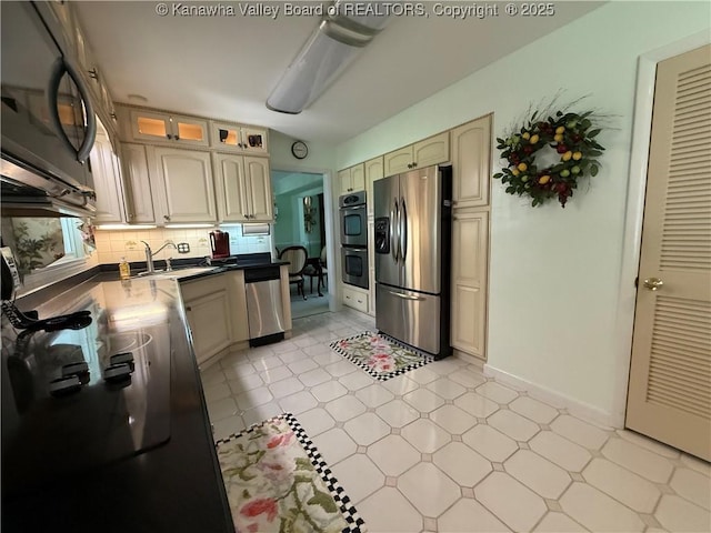 105 Sayer Cir, Logan, WV 25601 - kitchen featuring stainless steel appliances, decorative backsplash, glass insert cabinets, dark countertops, and cream cabinets