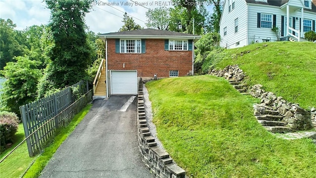 318 Monroe St, South Charleston, WV 25303 - view of front of house featuring asphalt driveway, brick siding, and a garage