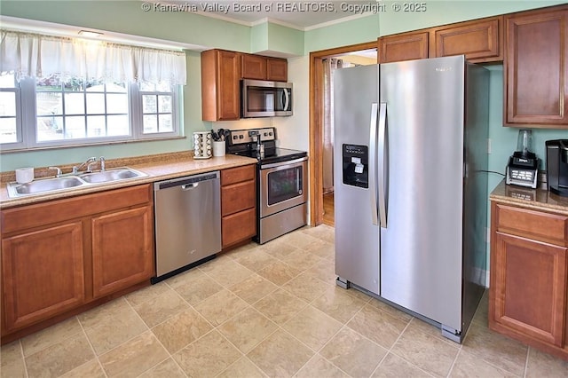 318 Monroe St, South Charleston, WV 25303 - kitchen with appliances with stainless steel finishes, crown molding, and brown cabinetry