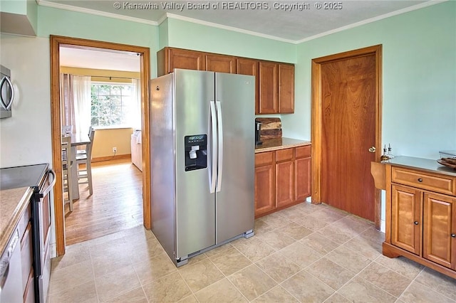 318 Monroe St, South Charleston, WV 25303 - kitchen with stainless steel appliances, brown cabinetry, ornamental molding, and light countertops
