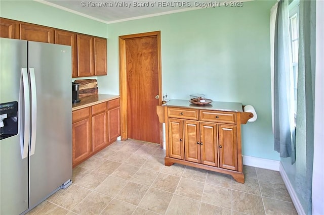 318 Monroe St, South Charleston, WV 25303 - kitchen featuring stainless steel fridge with ice dispenser, brown cabinets, light countertops, and crown molding