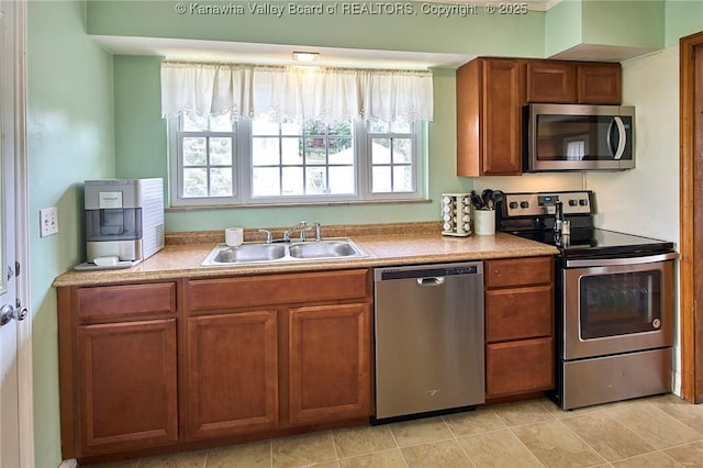 318 Monroe St, South Charleston, WV 25303 - kitchen with stainless steel appliances, brown cabinetry, and light countertops