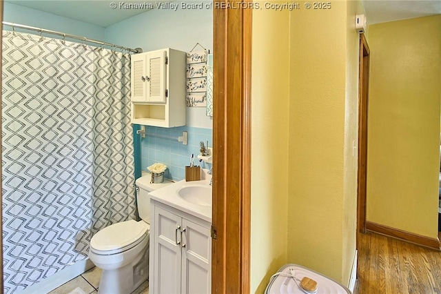 318 Monroe St, South Charleston, WV 25303 - bathroom with vanity, a shower with shower curtain, tile walls, and wood finished floors