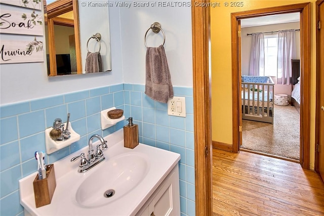 318 Monroe St, South Charleston, WV 25303 - bathroom with vanity, wood finished floors, tile walls, and a wainscoted wall