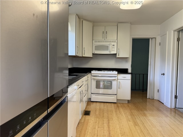119 Swarthmore Ave, Charleston, WV 25302 - kitchen featuring white appliances, light wood finished floors, dark countertops, and white cabinets